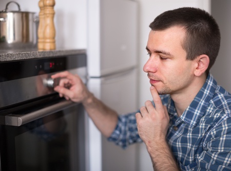 man thinking of oven issues