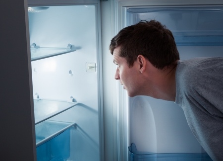 man checking freezer
