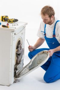 repair man repairing dryer