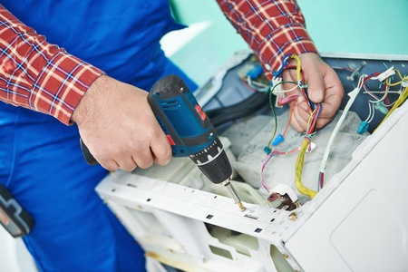 repairman working on a dryer