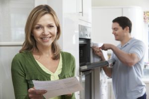 satisfied female customer with oven repair bill