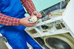 Washer technician checking the pressure switch