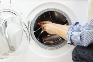 service technician repairing a washing machine